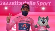 Ineos Grenadiers rider Egan Arley Bernal Gomez of Colombia celebrates wearing the maglia rosa on the podium after stage 16 REUTERS/Jennifer Lorenzini
