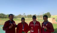 Qatari shooters pose for a group photo after winning bronze medal in team trap event.