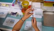 A healthcare worker prepares a dose of the Pfizer coronavirus disease (COVID-19) vaccine at a vaccination centre in Seixal, Portugal, September 11, 2021. Picture taken September 11, 2021. REUTERS/Pedro Nunes