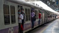 Commuters wearing protective face masks travel in a suburban train after authorities resumed the train services for all commuters after it was shut down to prevent the spread of the coronavirus disease (COVID-19), in Mumbai, India, February 1, 2021. REUTE