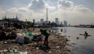 Angelita Imperio, a member of River Warriors, rakes through washed up trash from the heavily polluted Pasig River, at Baseco, Manila, Philippines, June 18, 2021. REUTERS/Eloisa Lopez/File Photo