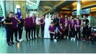 Qatar squash team players and officials pose for a photograph upon their arrival in Doha.