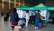 FILE PHOTO: Passengers queue to get a PCR test against the coronavirus disease (COVID-19) before traveling on international flights, at O.R. Tambo International Airport in Johannesburg, South Africa, November 26, 2021. REUTERS/Sumaya Hisham
