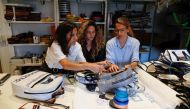 Sisters Carla, Ornella and Mora Basilotta, owners of the fashion firm Fracking Design discuss the design of a purse made with plastic sack used for holding sand in Vaca Muerta shale formation, in Buenos Aires, Argentina November 24, 2021. Picture taken November 24, 2021. REUTERS/Agustin Marcarian