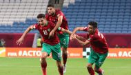 Morocco’s Mohamed Nahiri celebrates with Yahya Jabrane and Achraf Bencharki after scoring a goal against Palestine at Al Janoub Stadium, yesterday.