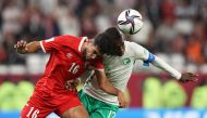 Saudi Arabia’s Saud Abdulhamid and Jordan’s Ali Olwan vie for the ball possession. 