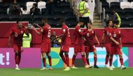 Hassan Al Haydos celebrates with teammates after scoring Qatar's third goal against Iraq on Monday.