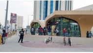 Commuters wait outside a metro station as services temporarily halted. Picture by: Abdul Basit/ The Peninsula