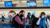 Passengers line up at John F. Kennedy International Airport during the spread of the Omicron coronavirus variant in Queens, New York City, U.S., December 26, 2021. REUTERS/Jeenah Moon
