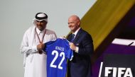 Prime Minister HE Sheikh Khalid bin Khalifa bin Abdulaziz Al Thani receives FIFA T-shirt from FIFA president HE Gianni Infantino during the FIFA Congress