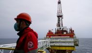 An employee is seen at an oil platform operated by Lukoil company at the Kravtsovskoye oilfield in the Baltic Sea. (REUTERS/Vitaly Nevar/File Photo)