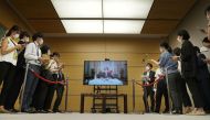 Japan's Prime Minister Fumio Kishida is seen on a screen as he answers remotely a question from reporters, after he tested positive for the coronavirus disease the previous day, at his residence in Tokyo, Japan, in this photo taken by Kyodo on August 22, 2022. (Reuters)
