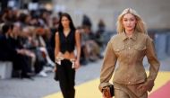 Models Bella Hadid and Gigi Hadid present creations by designer Stella McCartney as part of her Spring-Summer 2023 Women's ready-to-wear collection show during Paris Fashion Week in Paris, France, on October 3, 2022. (REUTERS/Johanna Geron)