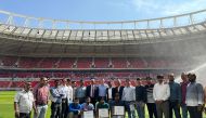 Officials pose for a group photo during a special celebration at Ahmad Bin Ali Stadium.