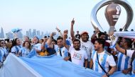 Argentina's fans cheer in front of the FIFA World Cup countdown clock in Doha on November 7, 2022, ahead of the Qatar 2022 FIFA World Cup football tournament. (Photo by Kirill KUDRYAVTSEV / AFP)