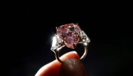 At 18.18 carats, the gem is the largest pear-shaped 'fancy vivid pink' diamond ever sold under the hammer. (AFP/Fabrice Coffrini)