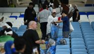 Japan fans clean up after the penalty shootout as Japan are eliminated from the World Cup. (REUTERS)