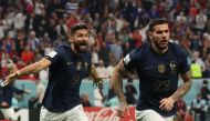 France's defender Theo Hernandez celebrates, with France's forward Olivier Giroud running behind, after scoring his team's first goal during the semi-final match on December 14, 2022. (Photo by Adrian Dennis / AFP)