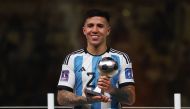 Argentina’s Enzo Fernandez poses with the Best Young Player award trophy. REUTERS