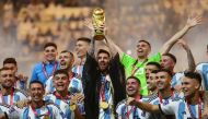 Argentina's Lionel Messi lifts the World Cup trophy alongside teammates as they celebrate winning the FIFA World Cup Qatar 2022 at the Lusail Stadium in Lusail on December 18, 2022. REUTERS/Carl Recine 

