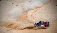 Audi's hybrid Spanish drivers Carlos Sainz and co-driver Lucas Cruz compete during the prologue of the Dakar 2023 by the Red Sea in Yanbu, Saudi Arabia, on December 31, 2022.  (Photo by FRANCK FIFE / AFP)