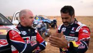 Nasser Al-Attiyah of Qatar (right), who tops the standings, with Giniel De Villiers after Tuesday's rain-affected Stage 3 of the Dakar 2023 between al-Ula and Hail in Saudi Arabia on January 3, 2023. (Photo by FRANCK FIFE / AFP)