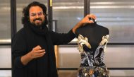 In this photograph taken on January 13, 2023, Indian fashion designer Rahul Mishra stands beside his new collection at his workshop in Noida. (Photo by Money Sharma / AFP)