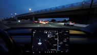 A Tesla Model 3 vehicle drives on autopilot along the 405 highway in Westminster, California, U.S., March 16, 2022. REUTERS/Mike Blake
