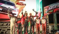 Qatar's Nasser Al Attiyah and co-driver Mathieu Baumel celebrate with other podium winners.