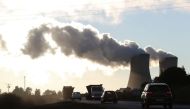 Trucks and cars are seen driving past while smoke rises from the Duvha coal-based power station owned by state power utility Eskom, in Emalahleni, in Mpumalanga province, South Africa, June 3, 2021. (REUTERS/Siphiwe Sibeko)