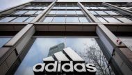 In this file photo taken on March 29, 2020 the logo of German sporting goods company Adidas is pictured at one of the company's outlets in Berlin, Germany. Photo by Odd ANDERSEN / AFP