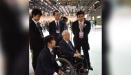 In this file photo taken on October 28, 2015 Shoichiro Toyoda (C), Japanese business leader serving as chairman of Toyota Motor, visits the Tokyo Motor Show. Photo by Kazuhiro NOGI / AFP