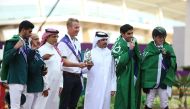 Qatar Equestrian and Modern Pentathlon Federation (QEMPF) President Badr Al Darwish presents the Nations Cup trophy to Saudi Arabia team’s Chef d’Equipe David Will at the Longines Arena at Al Shaqab yesterday. Sami Al Dahami, President of the Seventh Regional Group of the International Equestrian Federation (FEI) is also seen.