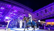 H E Sheikh Joaan bin Hamad Al Thani, President of the Qatar Olympic Committee and Jan Tops, President of the Longines Global Champions Tour applaud as Philipp Weishaupt of Germany arrives at the presentation ceremony after his victory.