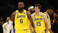 LeBron James #6 and Austin Reaves #15 of the Los Angeles Lakers react against the Memphis Grizzlies in overtime of Game Four of the Western Conference First Round Playoffs at Crypto.com Arena on April 24, 2023 in Los Angeles, California.  Photo by RONALD MARTINEZ /  Getty Images via AFP