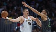 Nikola Jokic #15 of the Denver Nuggets is guarded by Rudy Gobert #27 of the Minnesota Timberwolves in the second quarter during Round 1 Game 5 of the NBA Playoffs at Ball Arena on April 25, 2023 in Denver, Colorado. Matthew Stockman/Getty Images/AFP 
