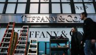 In this file photo taken on November 25, 2019, people walk by the Tiffany & Co flagship store along Fifth Avenue in the Manhattan borough of New York City. Photo by SPENCER PLATT / GETTY IMAGES NORTH AMERICA / AFP