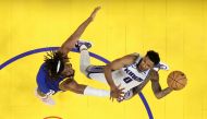 Malik Monk #0 of the Sacramento Kings goes up for a shot on Kevon Looney #5 of the Golden State Warriors during Game Six of the Western Conference First Round Playoffs at Chase Center on April 28, 2023 in San Francisco, California. (Photo by EZRA SHAW / GETTY IMAGES NORTH AMERICA / Getty Images via AFP)
