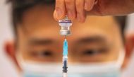 In this file photograph taken on December 21, 2021, a medical worker prepares a dose of a Covid-19 vaccine at a temporary vaccination centre set up in the Titanic Exhibition Centre in Belfast. (Photo by Paul Faith / AFP)