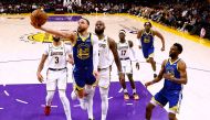 Stephen Curry #30 of the Golden State Warriors scores on a layup in front of LeBron James #6 of the Los Angeles Lakers. Ronald Martinez/Getty Images/AFP 
