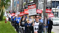 Writer Eric Heisserer hold his sign on the picket line on the fourth day of the strike by the Writers Guild of America in front of Netflix in Hollywood, California, on May 5, 2023. Photo by Frederic J. BROWN / AFP