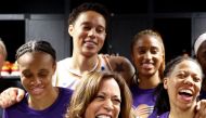 US Vice President Kamala Harris (C) laughs while standing with Brittney Griner (TOP) and other members of the Phoenix Mercury in the locker room before their game against the Los Angeles Sparks at Crypto.com Arena on May 19, 2023 in Los Angeles, California. Mario Tama/Getty Images/AFP 