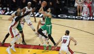 Derrick White #9 of the Boston Celtics drives to the basket ahead of Bam Adebayo #13 of the Miami Heat during the fourth quarter in game six of the Eastern Conference Finals at Kaseya Center on May 27, 2023 in Miami, Florida. Megan Briggs/Getty Images/AFP 