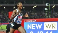 Kenya's Faith Kipyegon reacts as she wins the Women's 1500m event, setting a new world record of 3:49.11, during the Wanda Diamond League 2023 Golden Gala on June 2, 2023 at the Ridolfi stadium in Florence, Tuscany. (Photo by Filippo Monteforte / AFP)