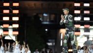 US Louis Vuitton' fashion designer and singer Pharrell Williams acknowledges the audience at the end of the Louis Vuitton Menswear Spring-Summer 2024 show as part of the Paris Fashion Week on the Pont Neuf, central Paris, on June 20, 2023. (Photo by Julien De Rosa / AFP)