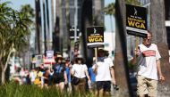 JULY 13: A sign reads 'SAG-AFTRA Supports WGA' as SAG-AFTRA members walk the picket line in solidarity with striking WGA (Writers Guild of America) workers outside Netflix offices on July 13, 2023 in Los Angeles, California. Photo by MARIO TAMA / GETTY IMAGES NORTH AMERICA / Getty Images via AFP