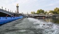 Triathlon athletes swim in The Seine river near the Alexandre III bridge during the men's 2023 World Triathlon Olympic Games Test Event in Paris, on August 18, 2023. Photo by Bertrand GUAY / AFP