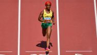 Jamaica's Shelly-Ann Fraser-Pryce crosses the finish line in the women's 100m heats during the World Athletics Championships at the National Athletics Centre in Budapest on August 20, 2023. (Photo by Andrej Isakovic / AFP)