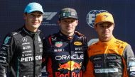 Mercedes' British driver George Russell (L), Red Bull Racing's Dutch driver Max Verstappen and McLaren's British driver Lando Norris pose after taking the leading positions in the qualifying session at The Circuit Zandvoort, ahead of the Dutch Formula One Grand Prix, in Zandvoort on August 26, 2023. (Photo by SIMON WOHLFAHRT / AFP)
