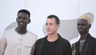 Actor Seydou Sarr (L), Italian director Matteo Garrone (C) and actor Moustapha Fall pose during the red carpet of the movie 